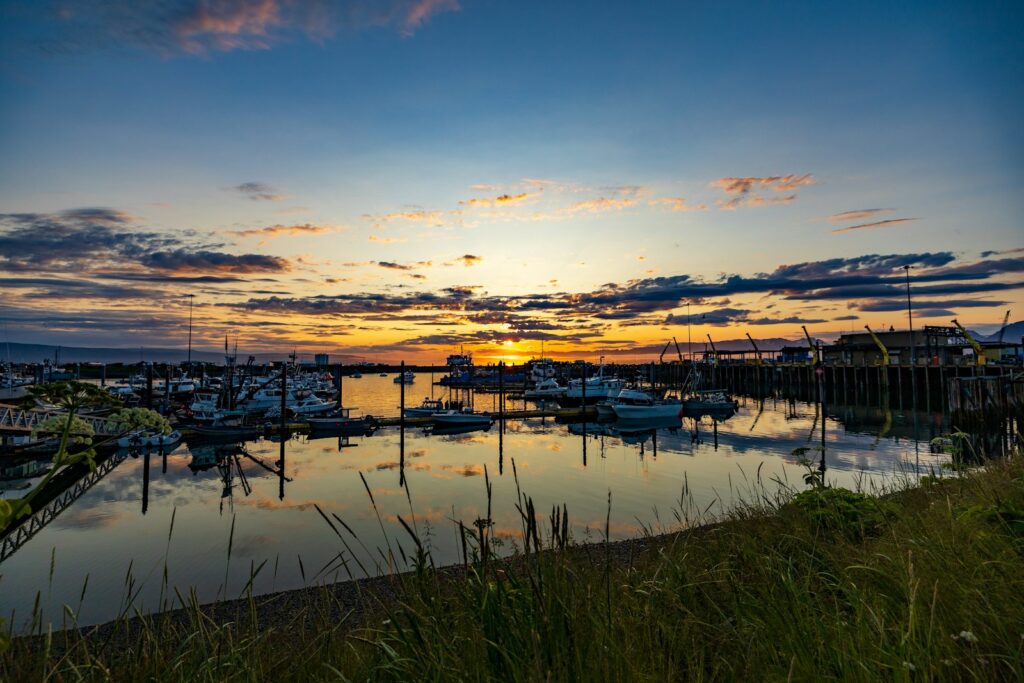 a harbor filled with lots of boats under a cloudy sky