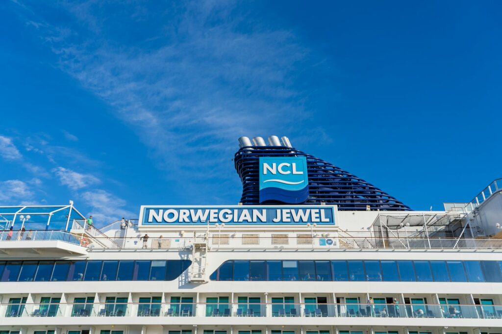 a cruise ship with a sign on top of it