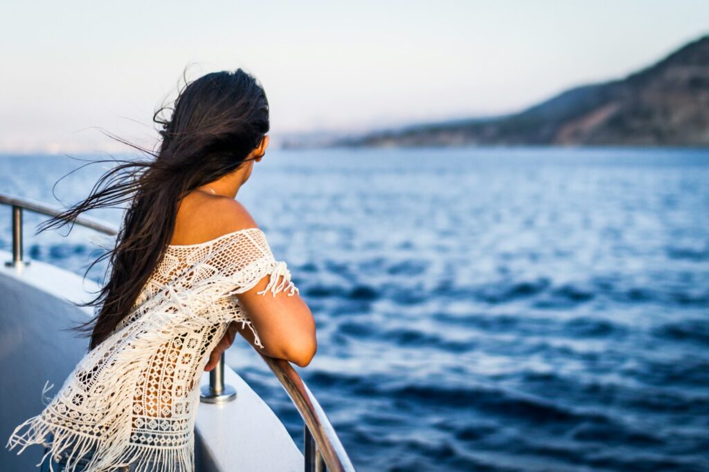 woman on the boat watching the sea - cruise photography tips