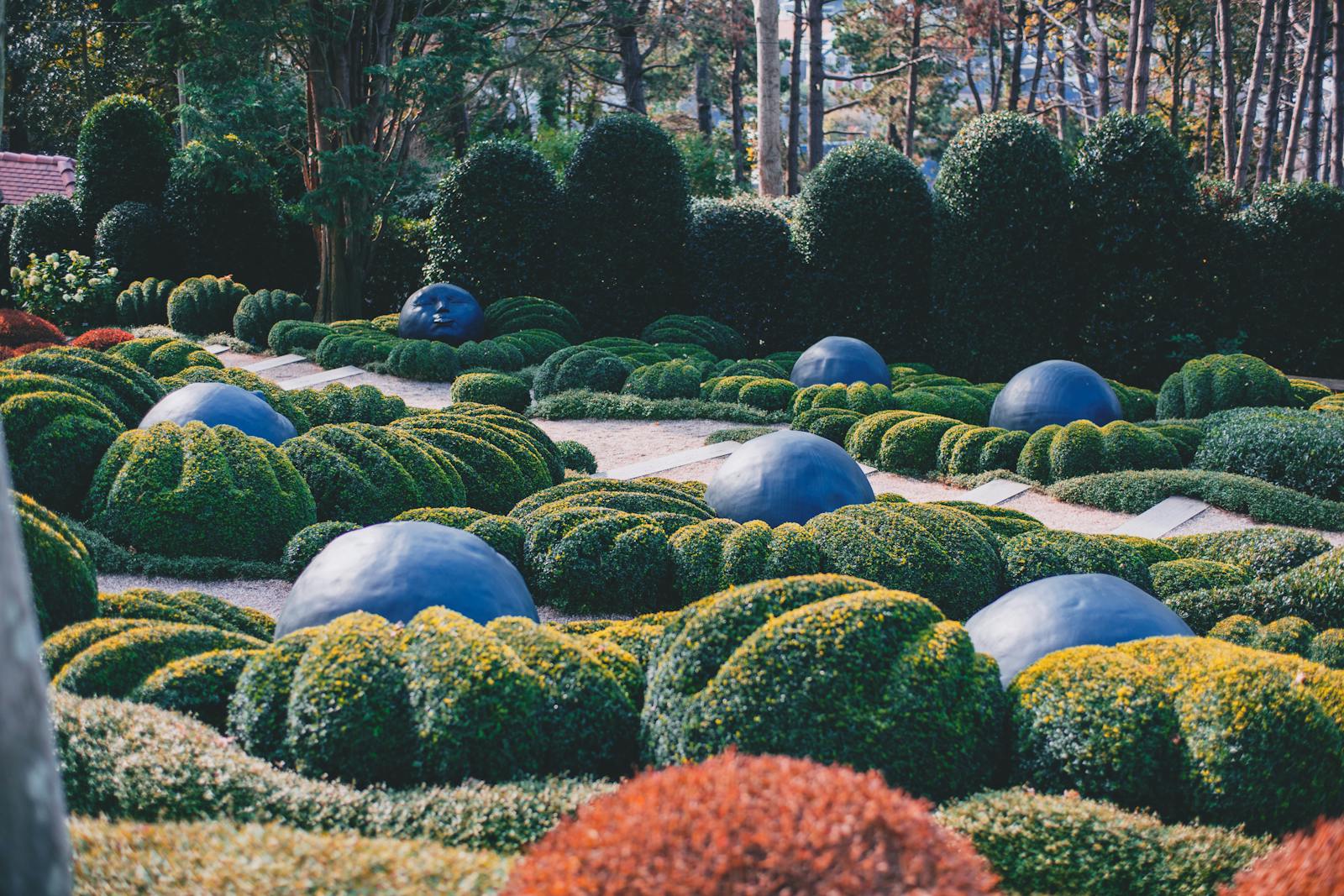 Etretat garden with green flowerbeds and blue stone representing emotions located in France on sunny summer day in nature