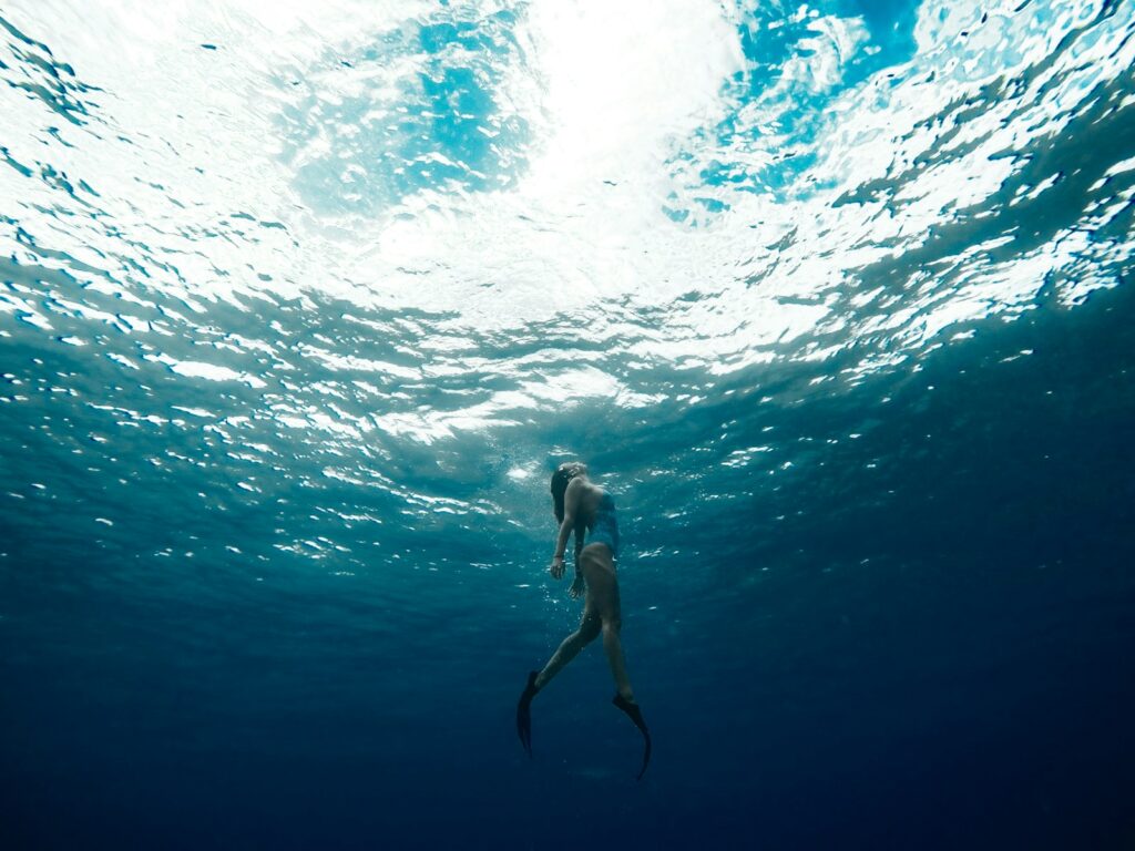 woman swimming underwater - things to do on a cruise