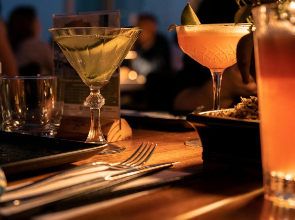 Wine Glass with Orange Liquid on Brown Wooden Table