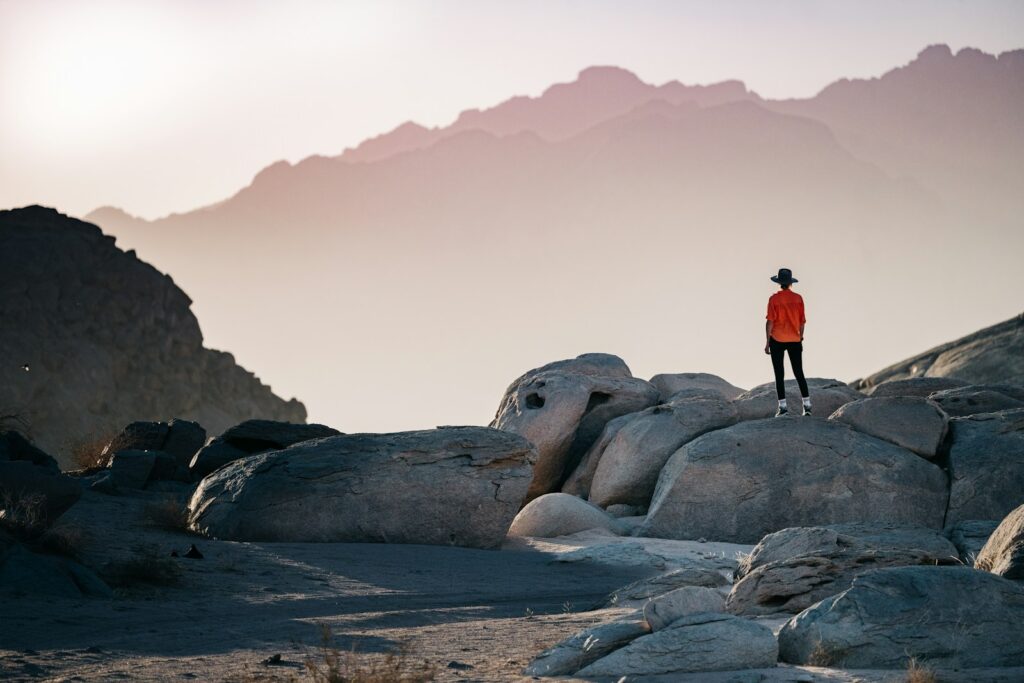 a person standing on top of a large rock - what to do on an Alaskan cruise