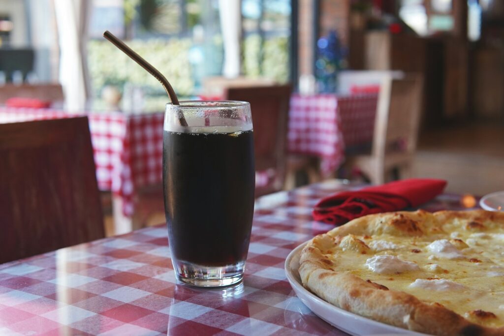 a pizza and a drink on a table