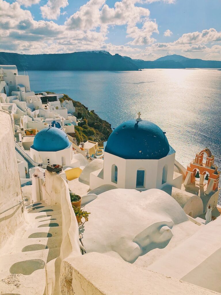 white and blue concrete building near body of water during daytime - Greece